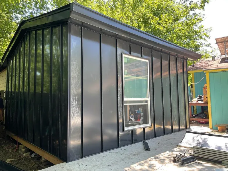 Black standing seam metal wall panels for Roof Inspection in De Witt